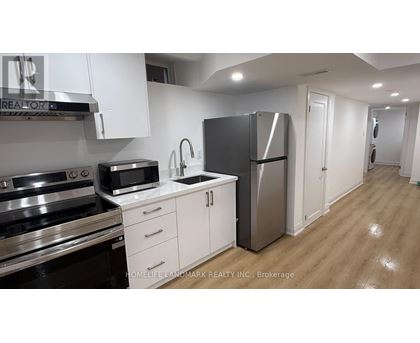 A kitchen with white cabinets and stainless steel appliances.