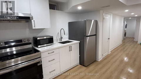 A kitchen with white cabinets and stainless steel appliances.