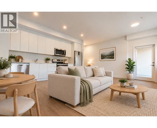 A living room with a couch, a table, and a chair.