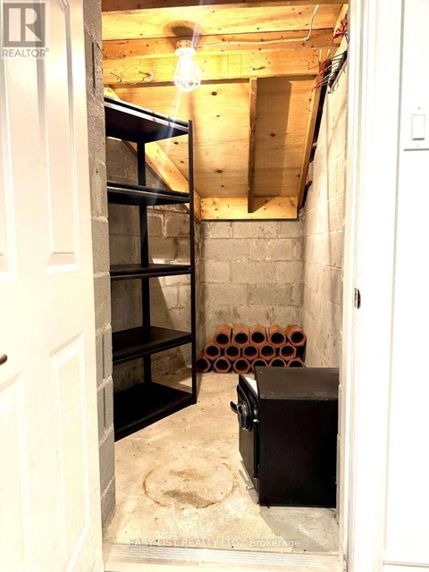 A room with exposed ceiling beams and a wooden floor.