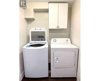 A white washing machine and dryer in a small laundry room.