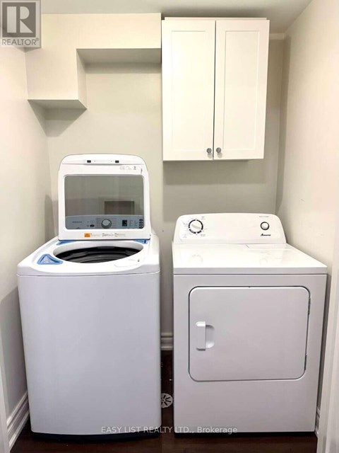 A white washing machine and dryer in a small laundry room.