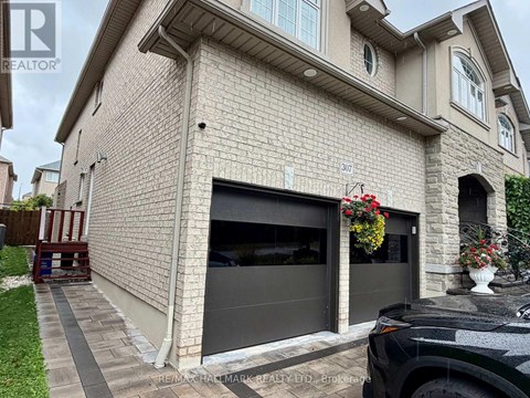 A house with a garage and a car parked in front.