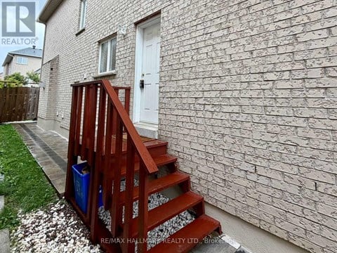 A house with a white door and a red staircase.