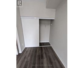 A room with a white closet and wooden floors.