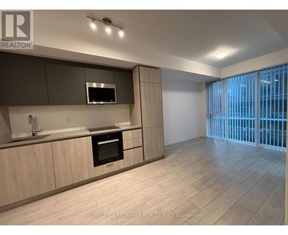 A modern kitchen with wooden cabinets and a stainless steel oven.