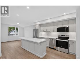 A modern kitchen with a large island and stainless steel appliances.