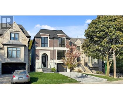 A row of houses with a car parked in front of the first one.