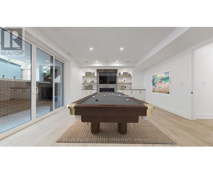 A pool table is in the middle of a room with a glass wall.
