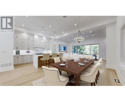 A modern dining room with a wooden table and chairs.