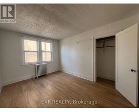 A room with EXP REALTY, Brokerage written on the wall.