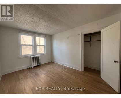 A room with EXP REALTY, Brokerage written on the wall.