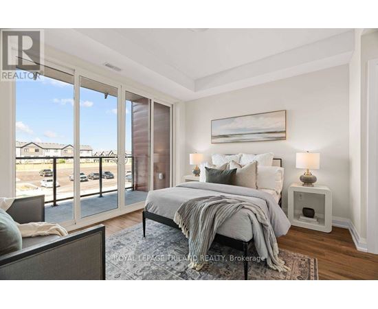 A bedroom with a large bed and a view of the outside.