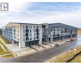 A building complex with cars parked in front.