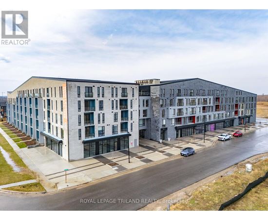 A building complex with cars parked in front.