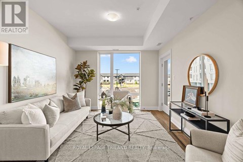 A well-lit living room with a large window and a view of the outside.