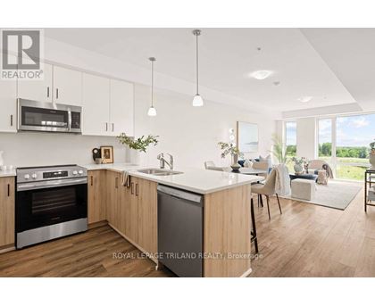 A modern kitchen with wooden cabinets and stainless steel appliances.