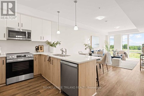 A modern kitchen with wooden cabinets and stainless steel appliances.