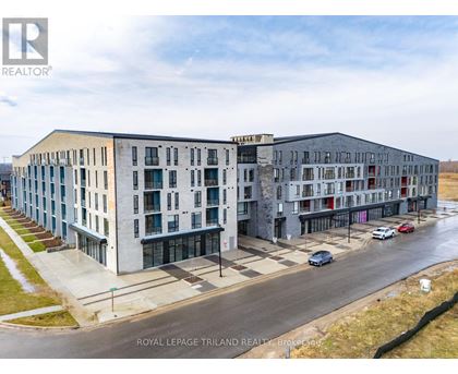 A building complex with cars parked in front.
