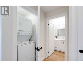 A white laundry room with a washer and dryer.