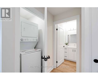 A white laundry room with a washer and dryer.