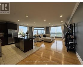 A modern kitchen with a bar area and a view of the city.