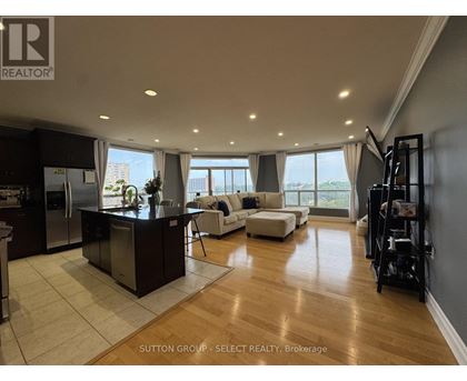 A modern kitchen with a bar area and a view of the city.