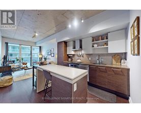 A kitchen with a white counter top and wooden cabinets.