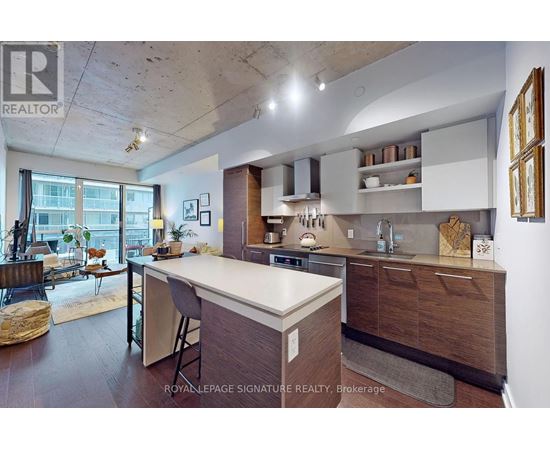 A kitchen with a white counter top and wooden cabinets.