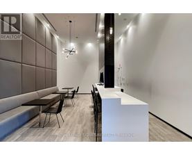 A modern office space with a reception desk and seating area.