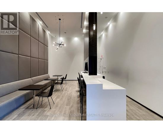 A modern office space with a reception desk and seating area.