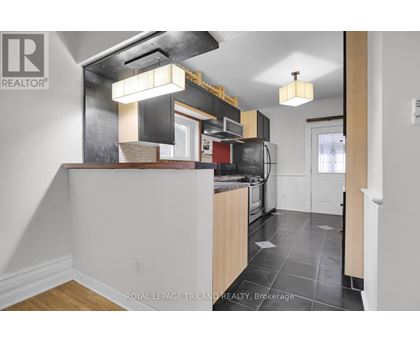 A kitchen with a white counter top and a black stove top oven.