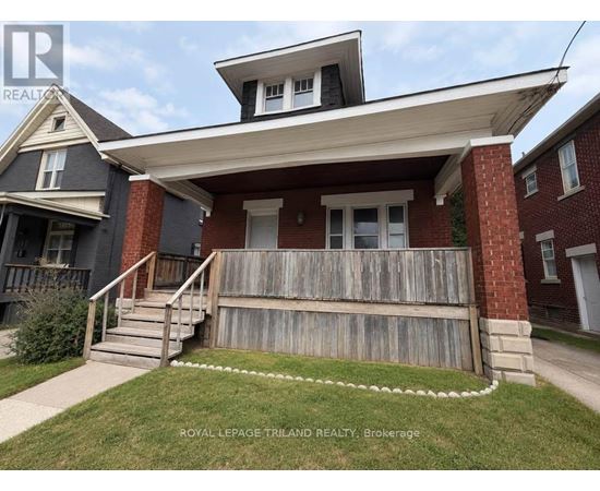 A house with a porch and a white picket fence.