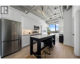 A modern kitchen with a large island and stainless steel appliances.
