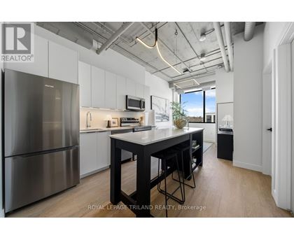 A modern kitchen with a large island and stainless steel appliances.