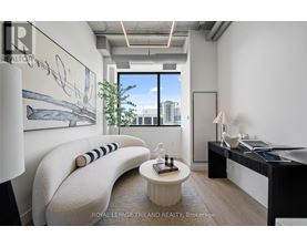 A modern living room with a large window and a view of the city.