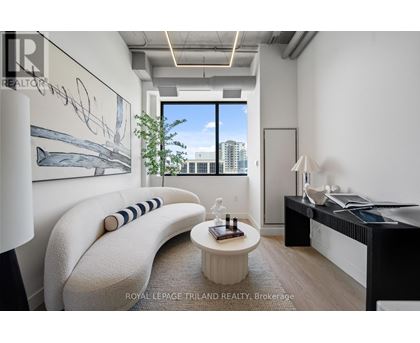 A modern living room with a large window and a view of the city.