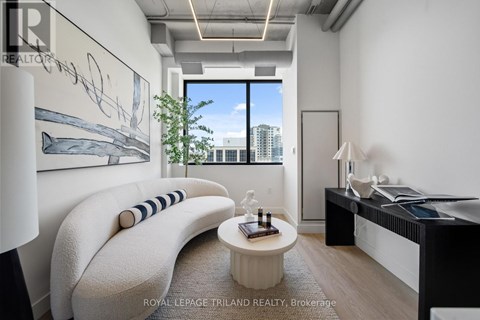 A modern living room with a large window and a view of the city.