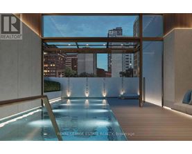 A modern indoor swimming pool with a view of the city.