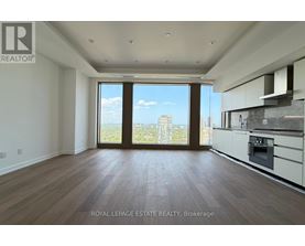 A spacious, empty room with a view of the cityscape outside the large window.