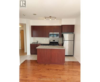 A kitchen with wooden cabinets and a granite countertop.
