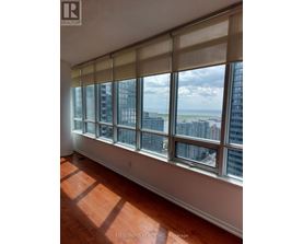 A room with a large window overlooking a cityscape.