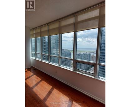 A room with a large window overlooking a cityscape.