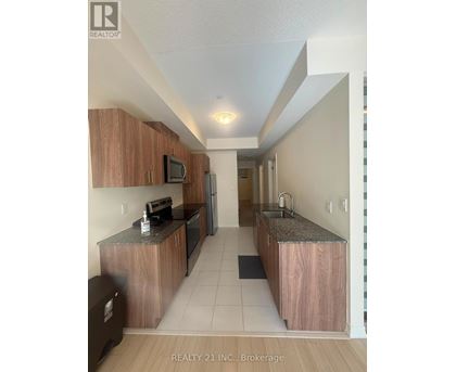 A kitchen with wooden cabinets and a granite countertop.