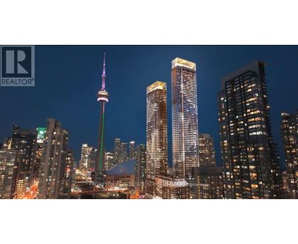 A cityscape at night with the CN Tower prominently lit up.