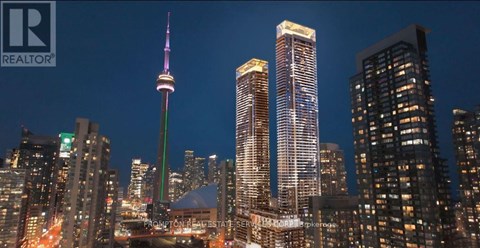 A cityscape at night with the CN Tower prominently lit up.
