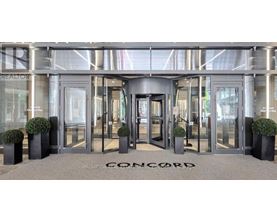 The front of a building with the word Concord written on the ground.
