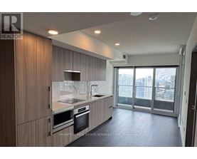A modern kitchen with wooden cabinets and stainless steel appliances.