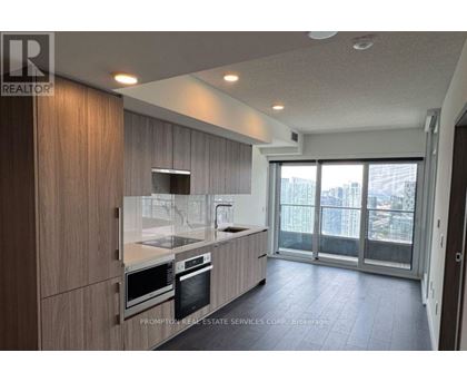 A modern kitchen with wooden cabinets and stainless steel appliances.