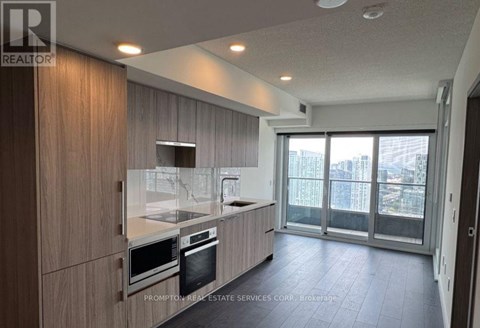 A modern kitchen with wooden cabinets and stainless steel appliances.